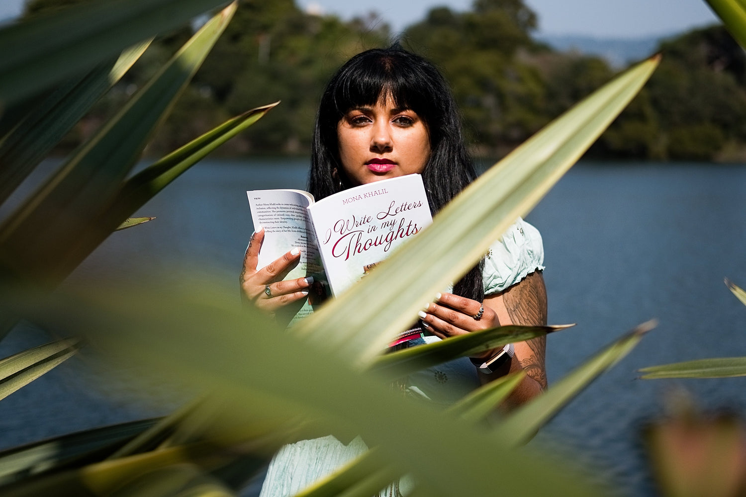 Holding book, I Write Letters in my Thoughts,  at Lake Merritt in Oakland, California.