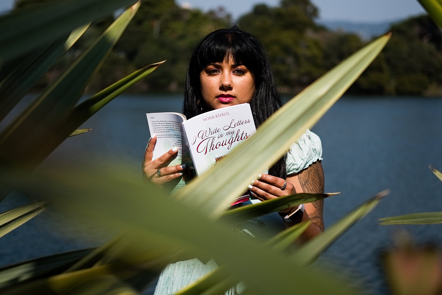 Holding book, I Write Letters in my Thoughts,  at Lake Merritt in Oakland, California.